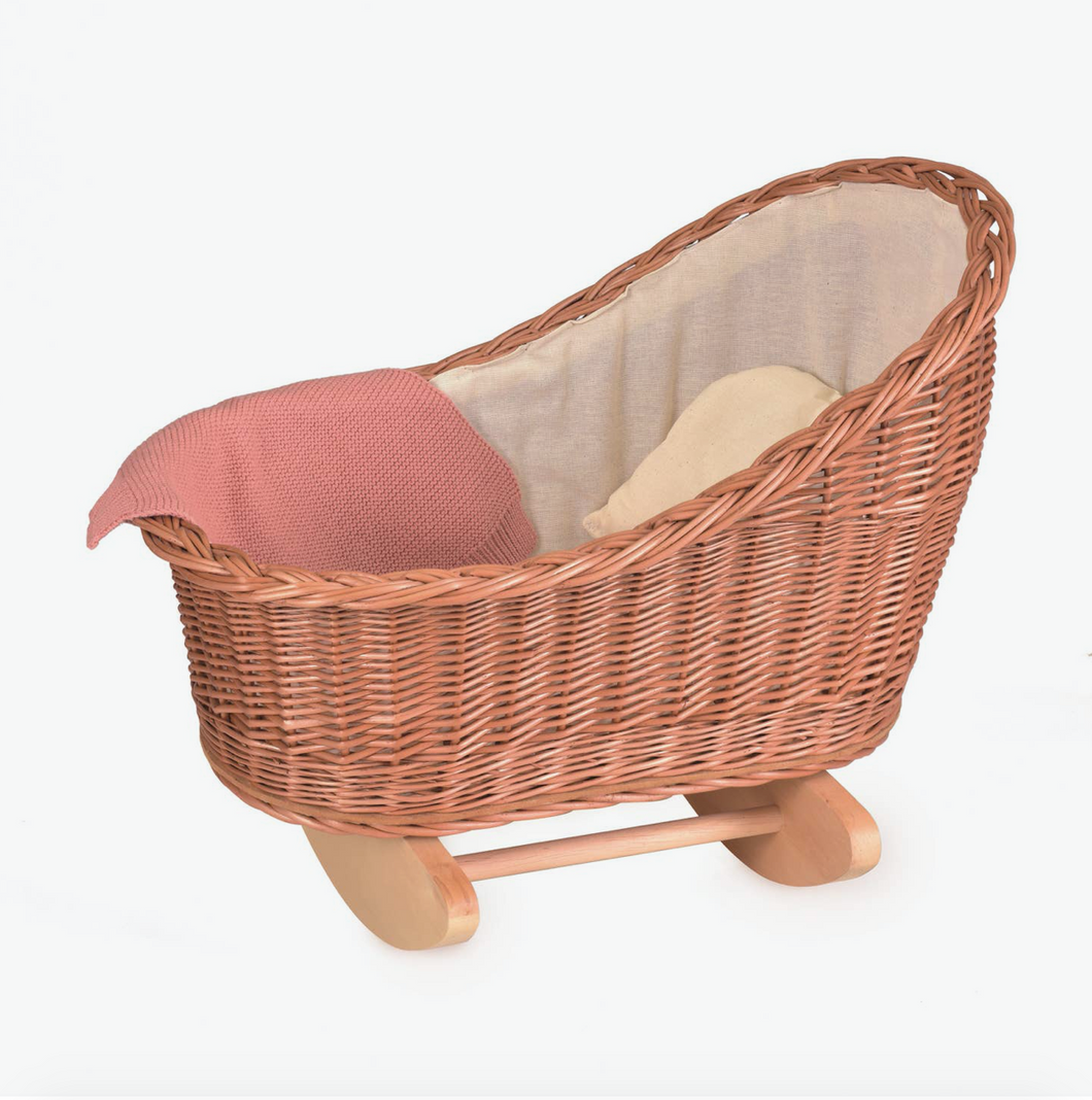 wicker cradle with knitted blanket