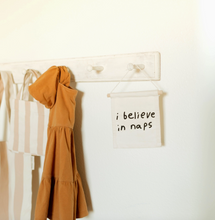 'i believe in naps' wall hanging